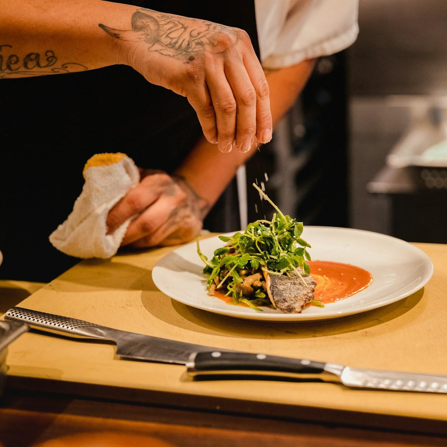 Community members collaborating in a modern kitchen, sharing recipes and techniques